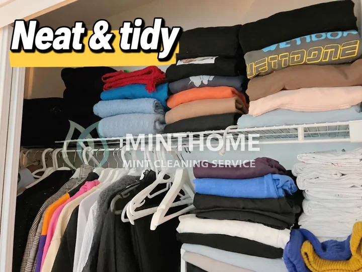 Folded and put away — Clothing folded on shelves and arranged on hangers after organizing.