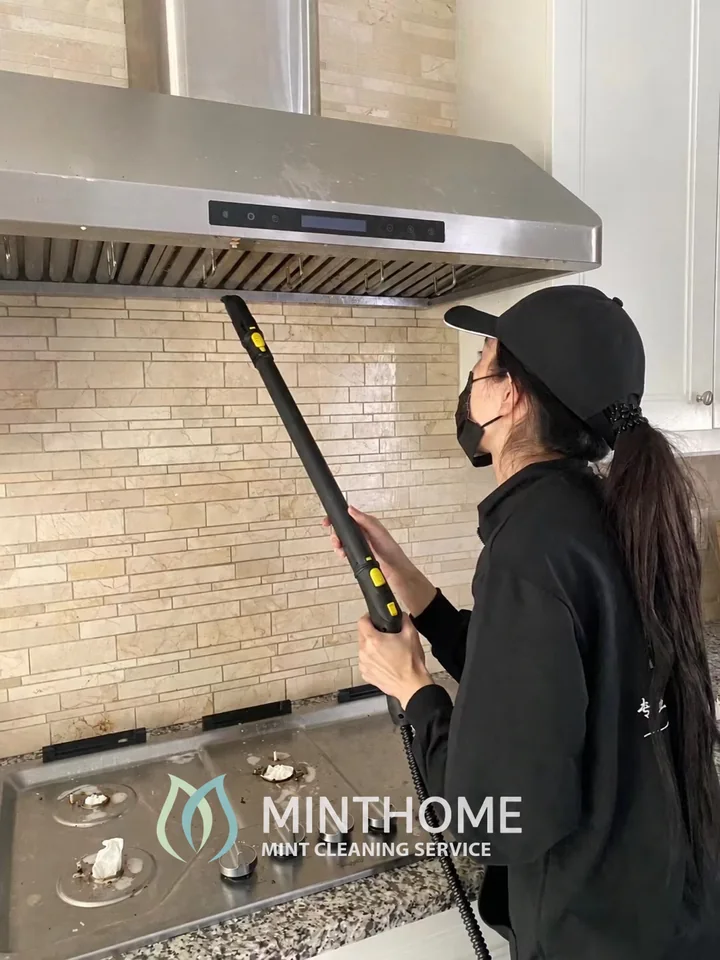 Care around the range hood — A MintHome cleaner at work. Tools and methods are chosen for the surface; hood work is confirmed separately.